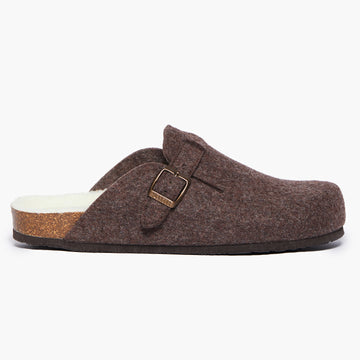 A dark brown wool felt slipper with a adjustable strap and a cork insole,on a white background. Handmade in Spain.